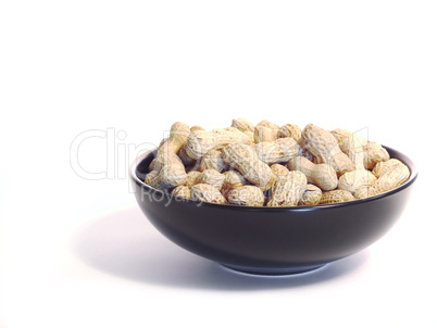 Black bowl with unshelled peanuts