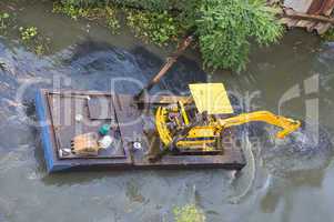 Small dredge doing maintenance on a
