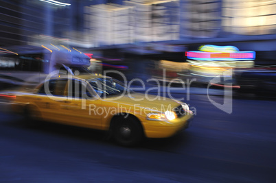 Taxi cab speeding down a city stree