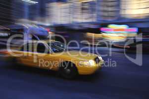 Taxi cab speeding down a city stree