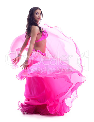 Dancer in pink costume performing oriental dance