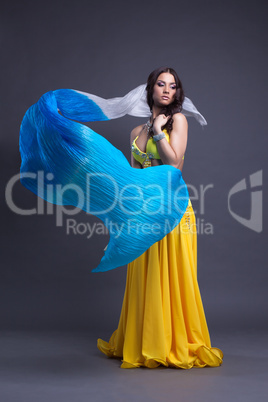 Young dancer in yellow costume dance with fantail