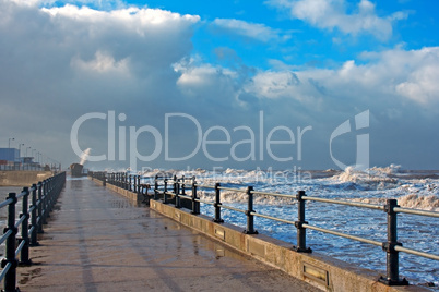 Huge waves crashing onto promenade