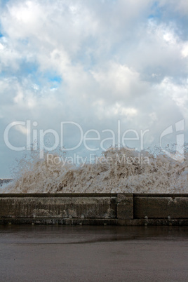 Huge waves crashing onto promenade