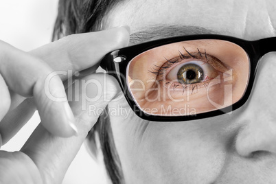 Woman holding glasses to see better