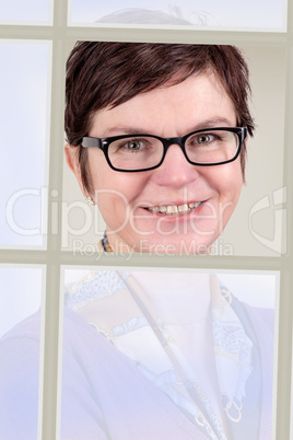 Businesswoman looking through the open window
