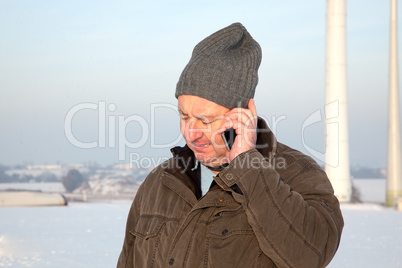 Man in winter when phoning