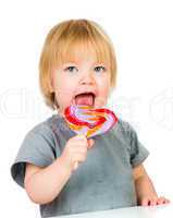 Baby eating a sticky lollipop