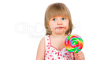 Baby girl eating a sticky lollipop