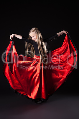 Happy little girl performing hispanic dance