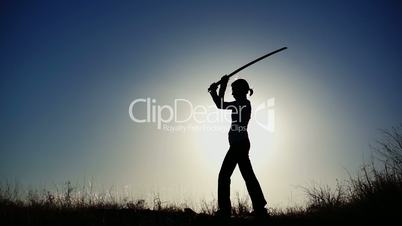 Silhouette of Girl Practicing With Sword
