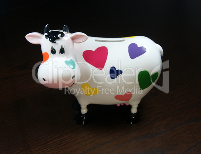 Moneybox as a cow with painted hearts