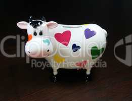 Moneybox as a cow with painted hearts