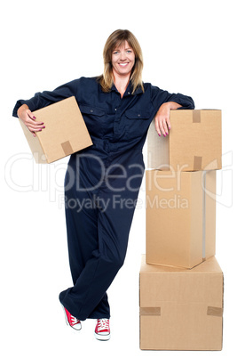 Charming woman in uniform posing with cartons