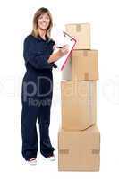Happy delivery woman preparing an invoice