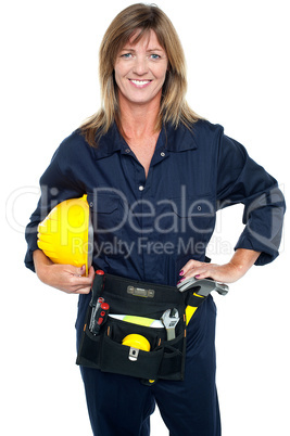 Self assured female architect holding hard hat