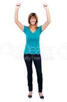 Excited woman in celebration mood with raised arms