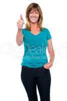 Stylish blonde woman gesturing thumbs up