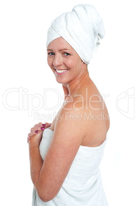 Cheerful spa woman wearing bathing towel