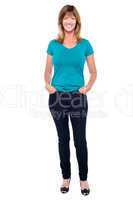 Casual trendy woman with hands in jeans pocket