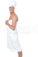 Gorgeous female in bath towel posing sideways