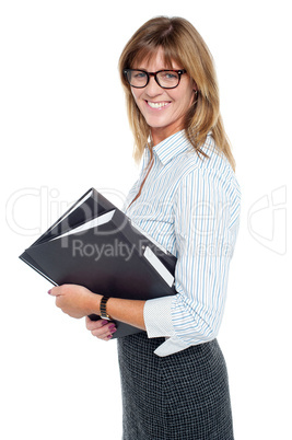 Smiling businesswoman carrying important files