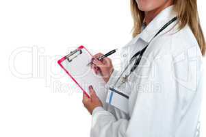Cropped image of doctor writing on clipboard