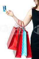 Woman holding colorful shopping bags and cash card