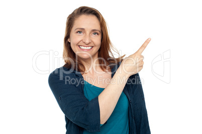 Joyous smart woman pointing away