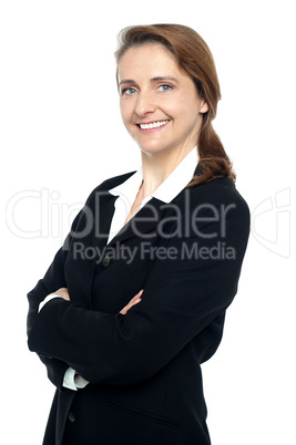 Executive in business suit standing arms folded