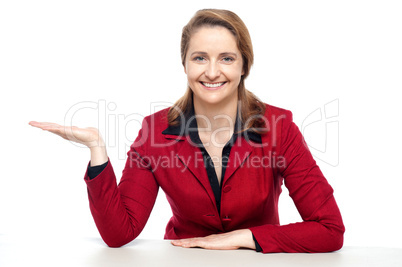 Happy corporate woman presenting copy space