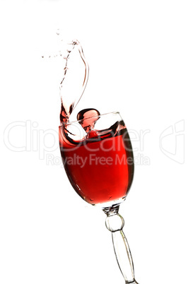 Splashing glass of red wine