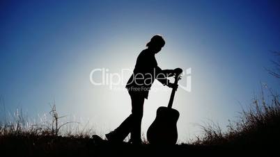 Silhouette of a Girl With Her Guitar