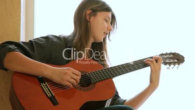 Teen Girl Playing Guitar