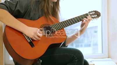 Teen Girl Playing Guitar