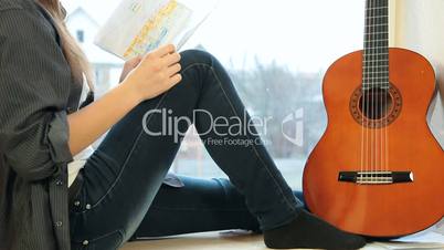 Teenager Girl Studying Guitar Fingerings