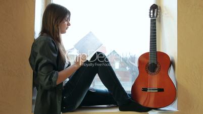 Teenager Girl Studying Guitar Chart