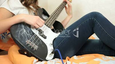 Teen Girl Playing Bass Guitar