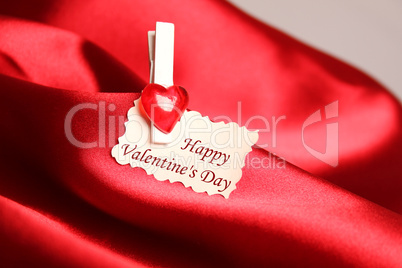 Greeting card for Valentine's Day, on red satin