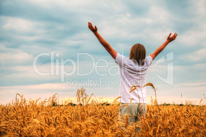 Young man staying with raised hands