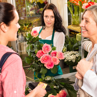 Women customers buying card flower shop pink