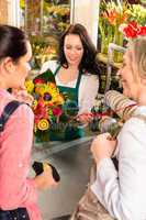 Happy women customers buying flowers sunflower bouquet