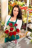 Florist woman arranging flowers roses shop working