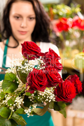 Young woman making flower bouquet florist shop