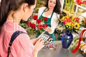 Woman customer paying flowers shop credit card