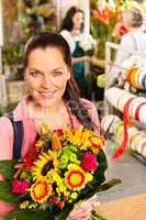 Smiling young florist woman colorful bouquet shop