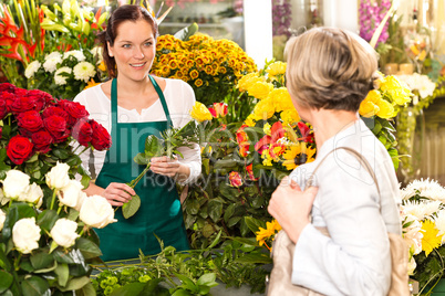Young woman arranging flowers shop market selling