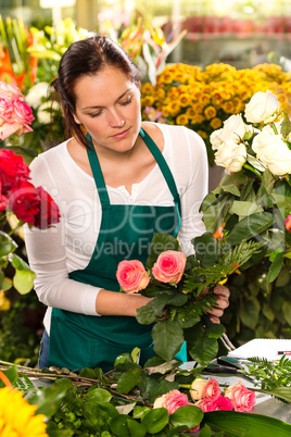 Woman florist preparing bouquet flowers shop retail