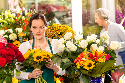 Woman florist selling sunflowers bouquet flower shop