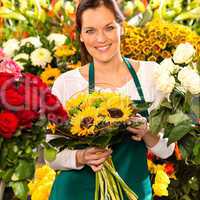 Smiling florist woman bouquet sunflowers flower shop